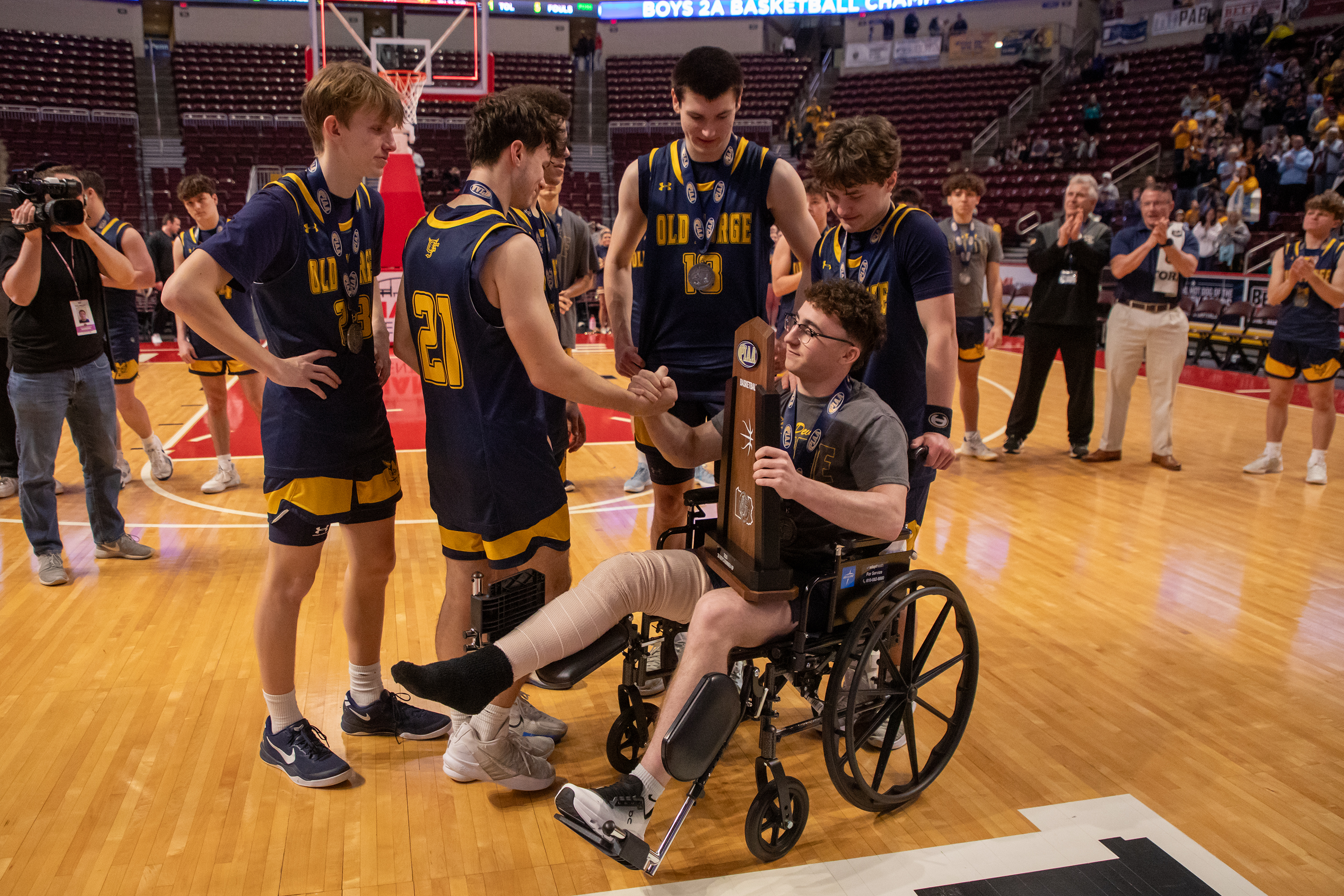 Old Forge’s Ryan DeMarco shakes hands with his teammate Nick...