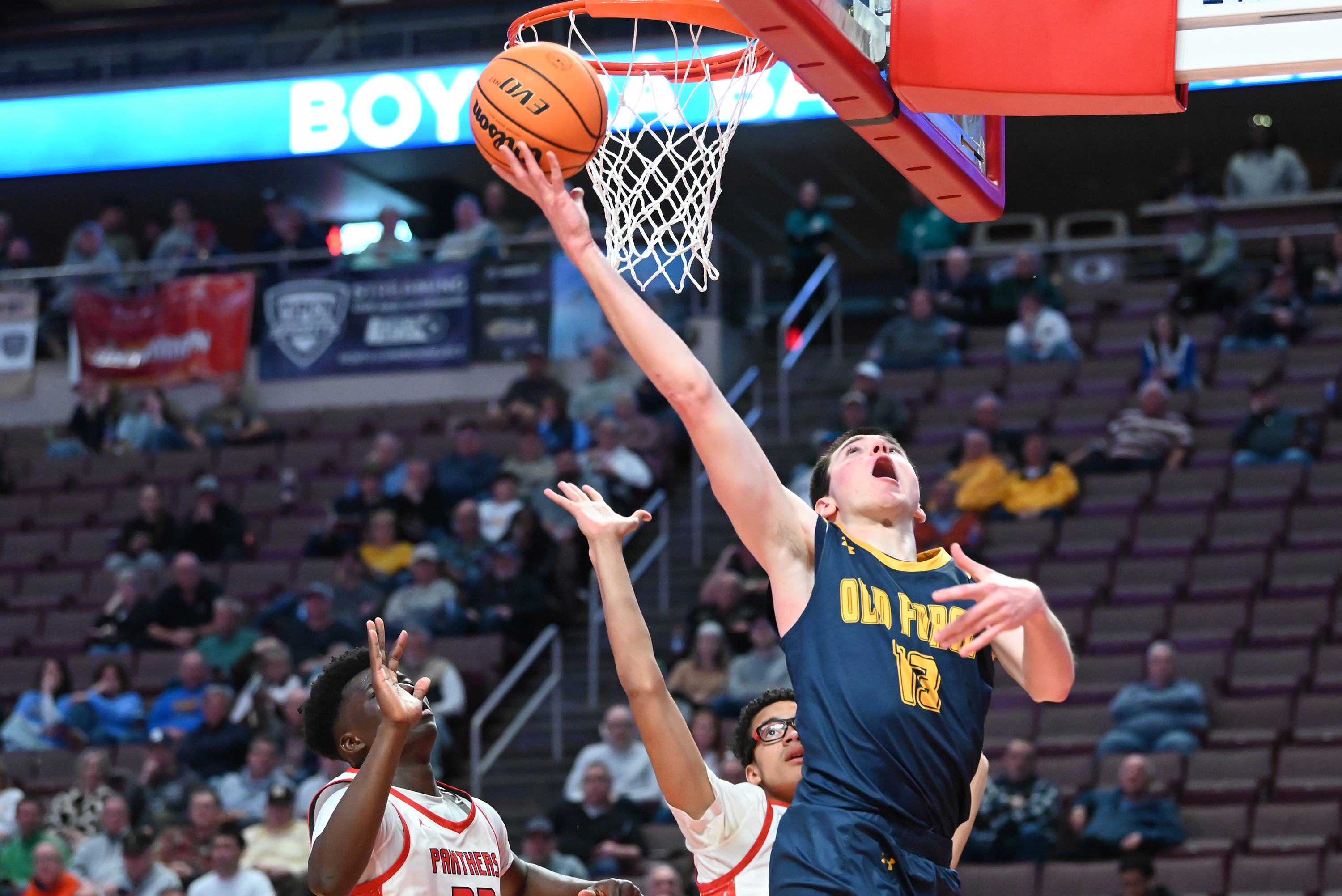 Old Forge’s Logan Fanning lifts the ball to the hoop...