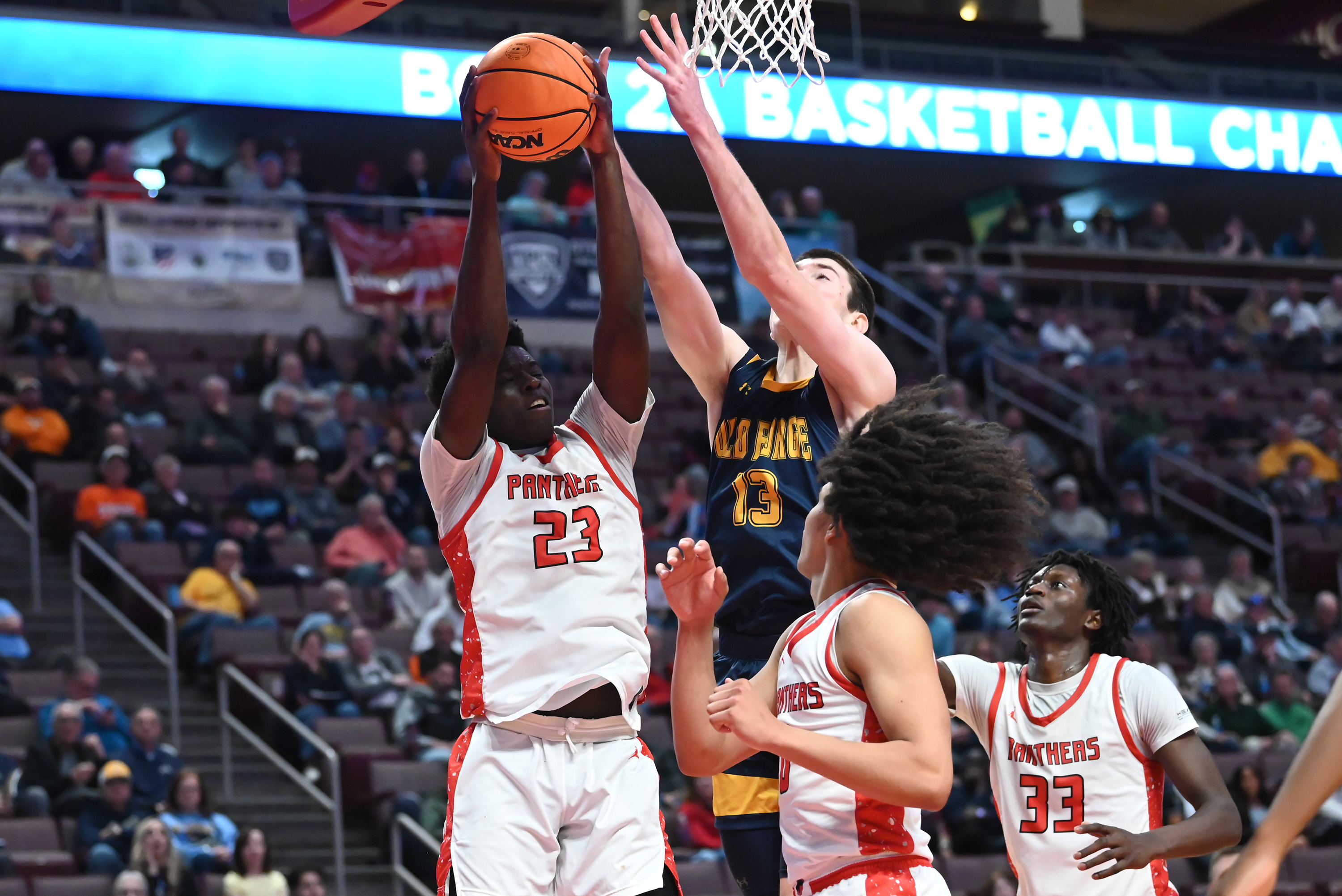 Old Forge’s Logan Fanning competes for the rebound with Sewickley...