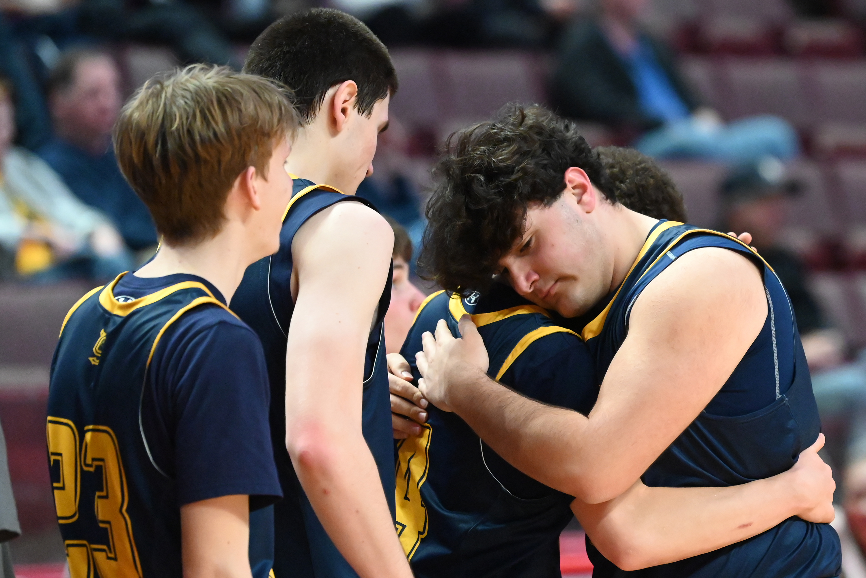 Old Forge’s Jake Lucarelli hugs teammate Cameron Parker as he...