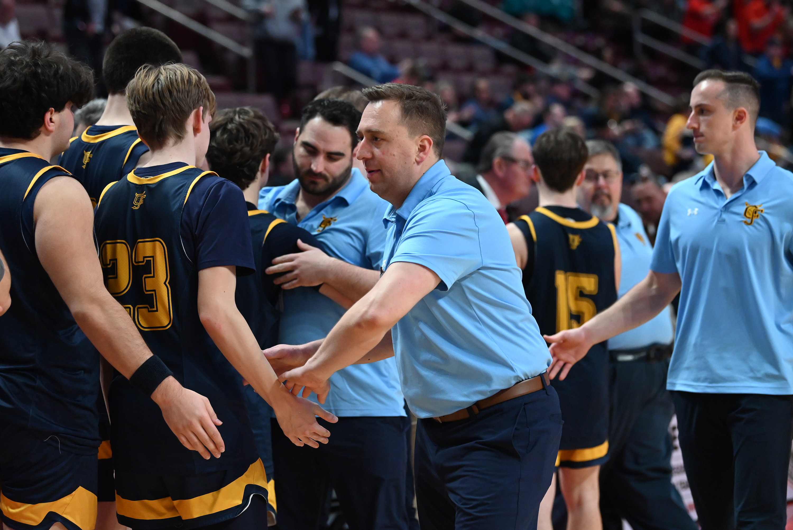 Old Forge’s head coach JJ Thomas high fives his team...