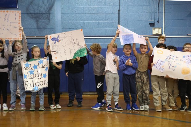 Students hold up signs in support of the Lady Falcons during the pep rally at Our Lady of Peace School in Clarks Green on Thursday, March 12, 2026. The girls basketball team will represent the Diocese of Scranton in the Catholic Youth Organization State Tournament in the Archdiocese of Philadelphia this weekend. (REBECCA PARTICKA/STAFF PHOTOGRAPHER)