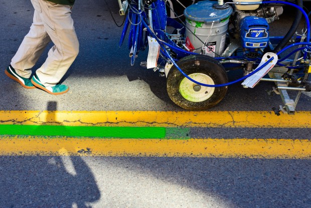 Scranton Department of Public Works employee Gene Reed paints the center of Wyoming Ave. with a green line Monday following the parade route for the Scranton St. Patrick's Parade, set for this Saturday.