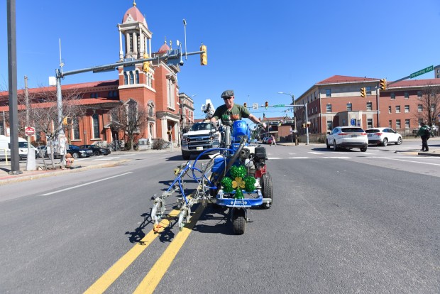 Scranton Department of Public Works employee Gene Reed paints the center of Wyoming Ave. with a green line Monday following the parade route for the Scranton St. Patrick's Parade, set for this Saturday.