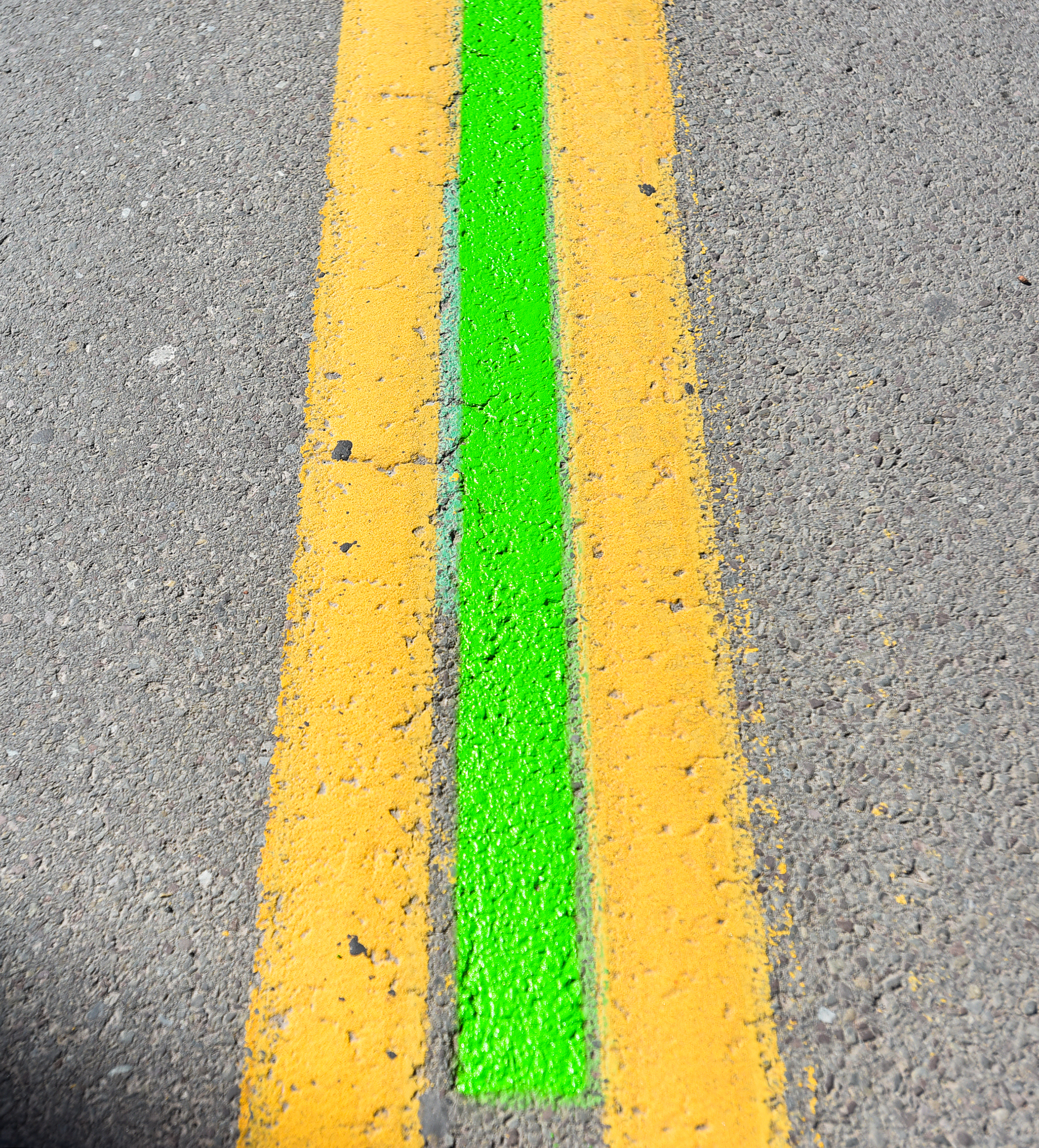 A green painted line is applied to the center of...