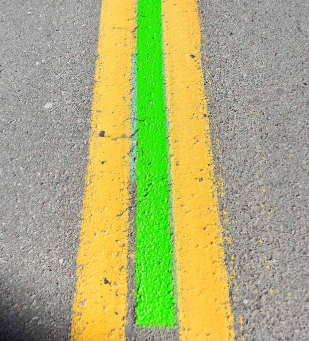 A green painted line is applied to the center of Wyoming Ave. in downtown Scranton along the parade route for the Scranton St. Patrick's Parade, set for this Saturday.
