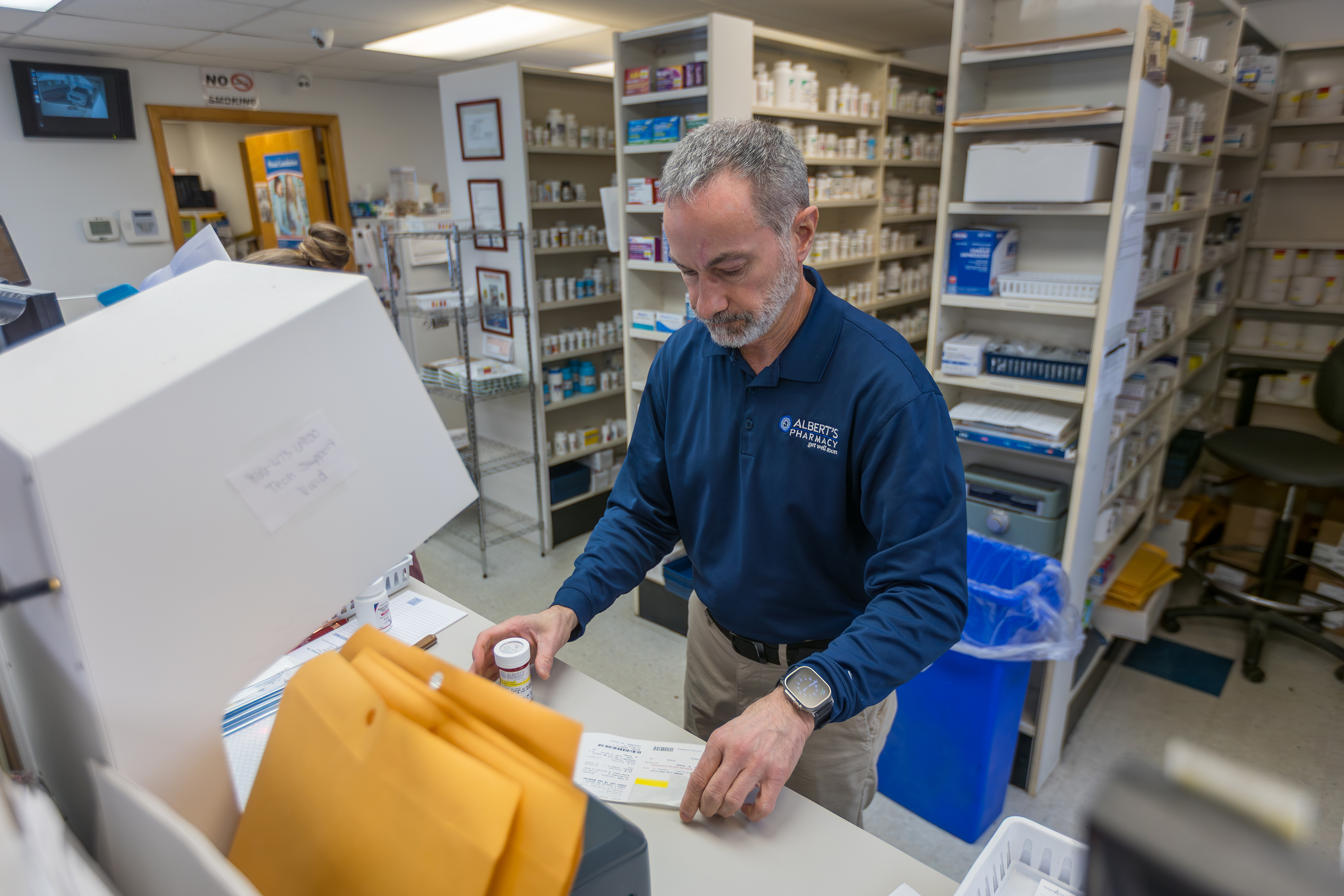 Joe Albert, owner of Albert’s Pharmacy in Pittston, fills a...