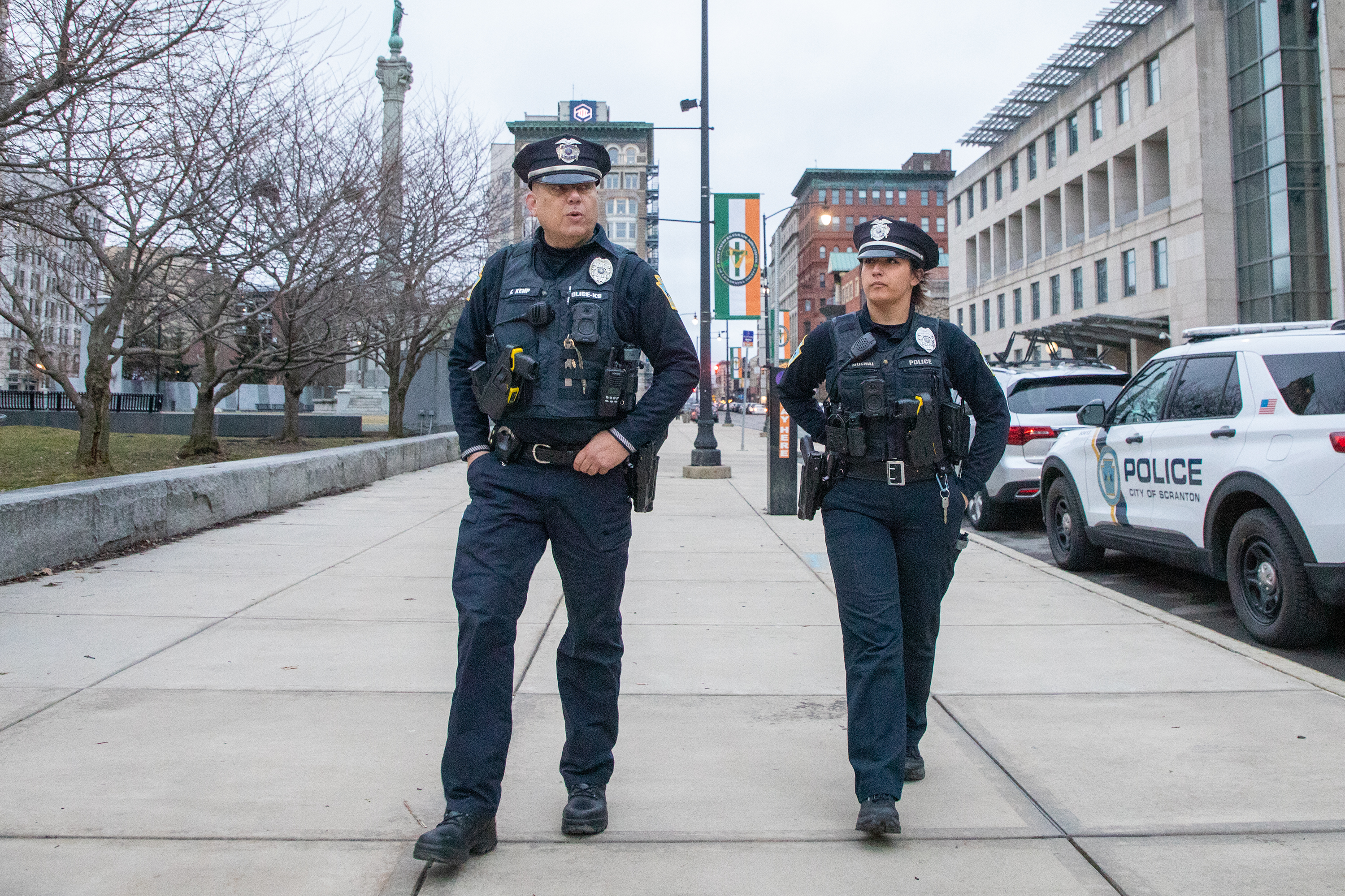Patrol officers Kyle Kemp and Olivia Muchal walk Courthouse Square...