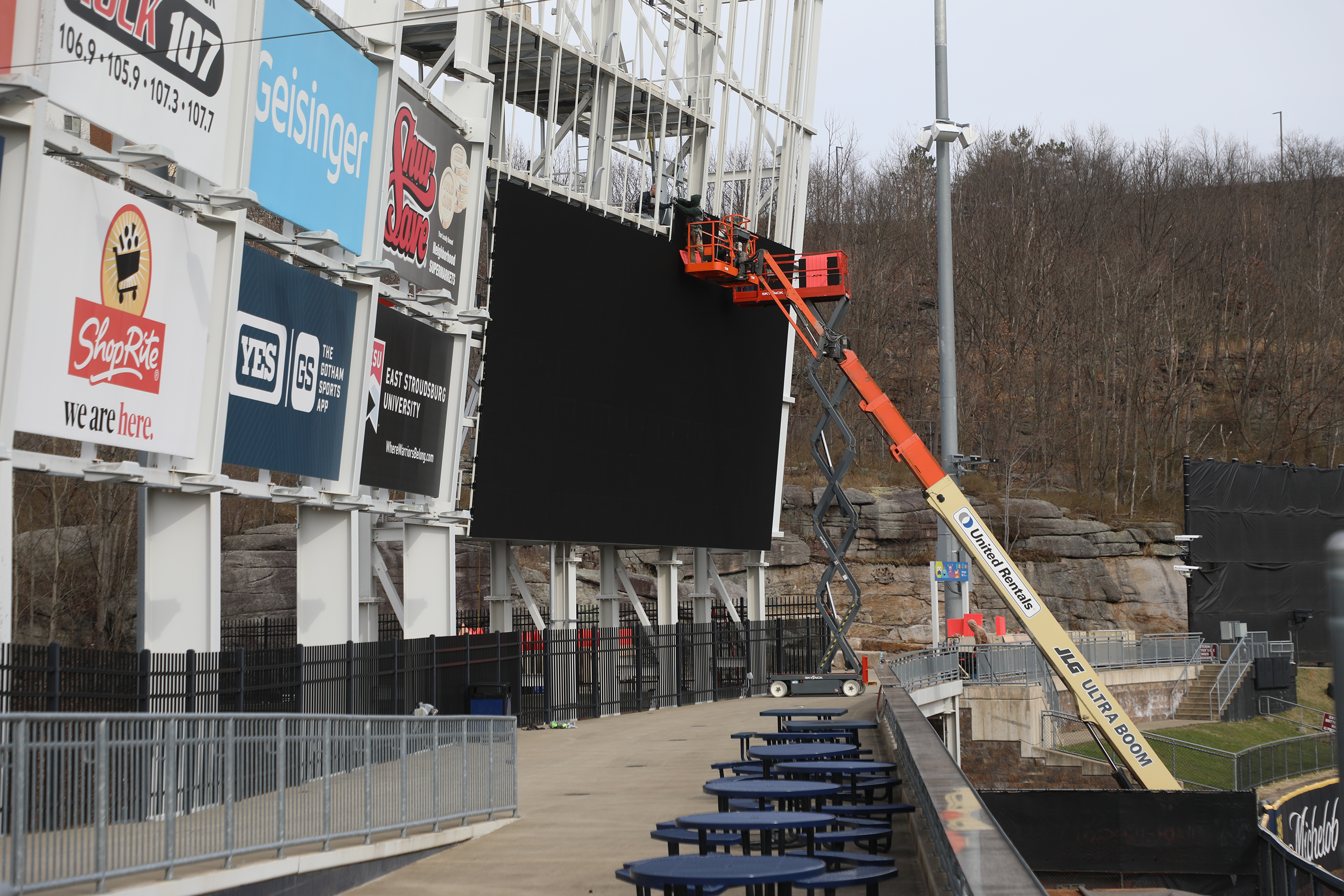 Crews work at installing the new video board at PNC...
