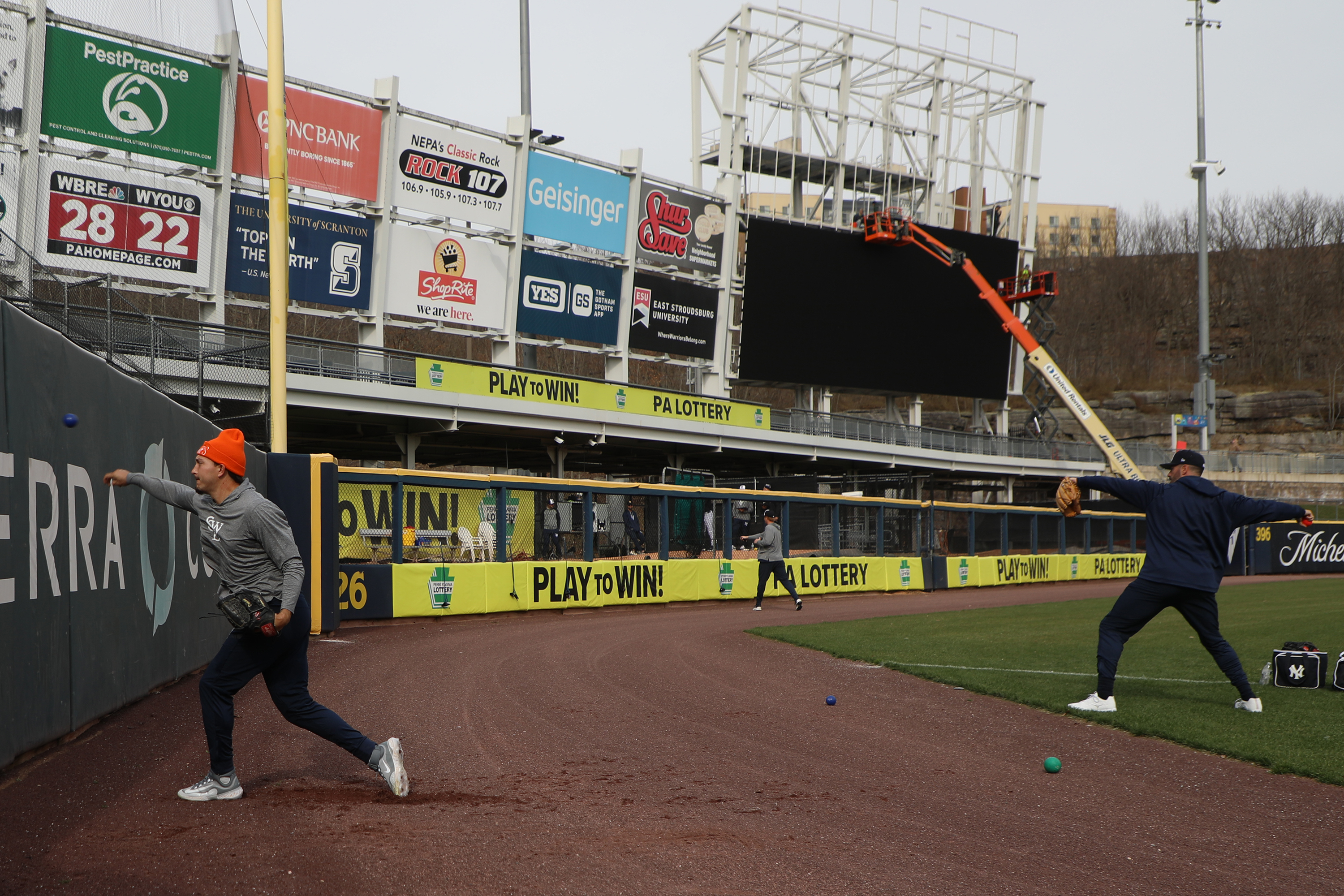 Players practice as work continues on the new video board...