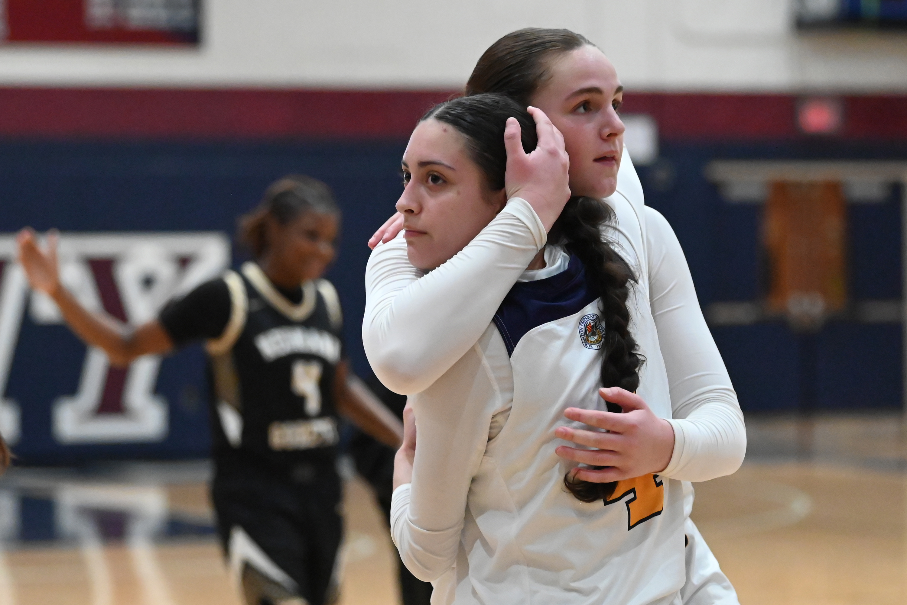 Scranton Prep’s Chloe Mamera embraces teammate Ava Fenton after losing...