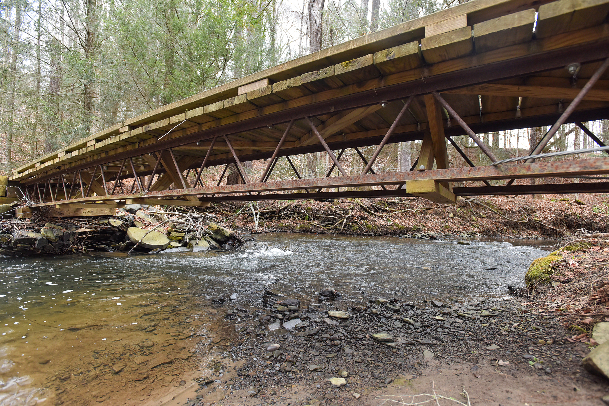 A trail bridge stretches over Kennedy Creek along the Ranger...
