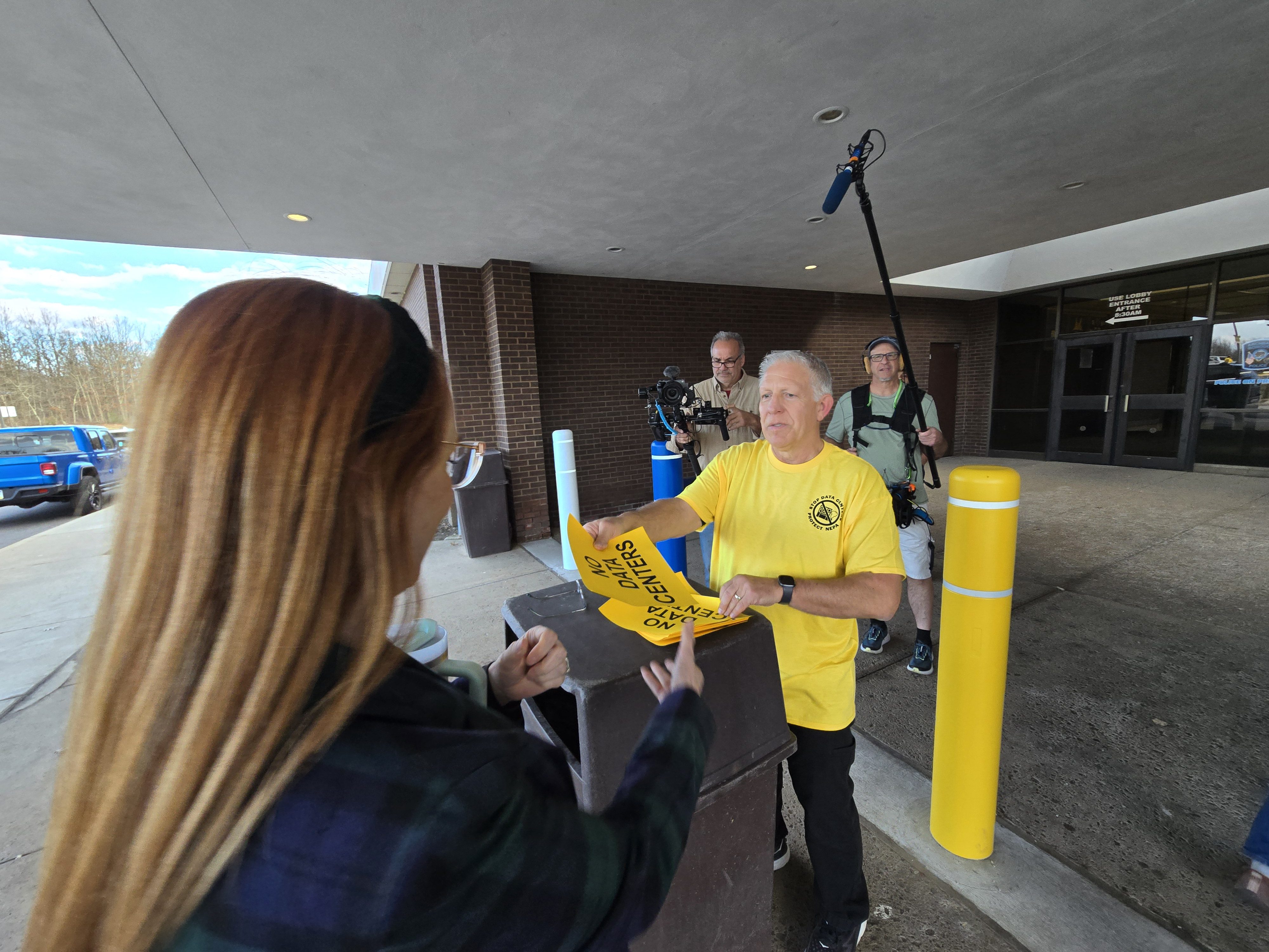 Archbald resident David Polansky hands out “NO DATA CENTER” signs...