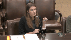 Paige Rodrigues holds up a model high performance conductor while testifying at a House Energy Committee meeting on Monday, March 16, 2026. (Screenshot from livestream)
