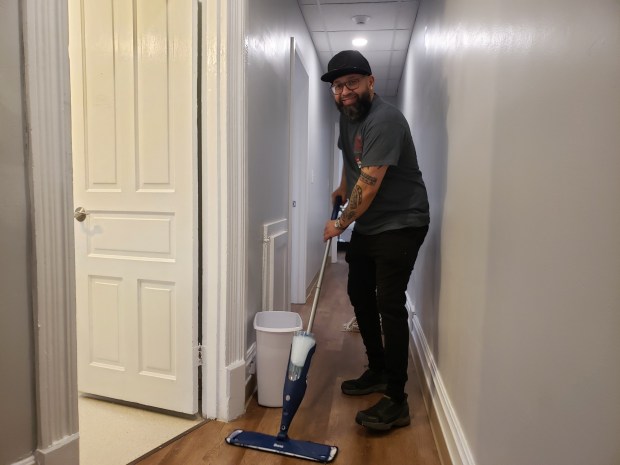 Manuel Sosa of Legend Truck Body and Premier Fleet Services, Leesport, cleans floors at Hope House in time to welcome 13 residents to the refurbished group home on South Ninth Street. (MICHELLE LYNCH/READING EAGLE)