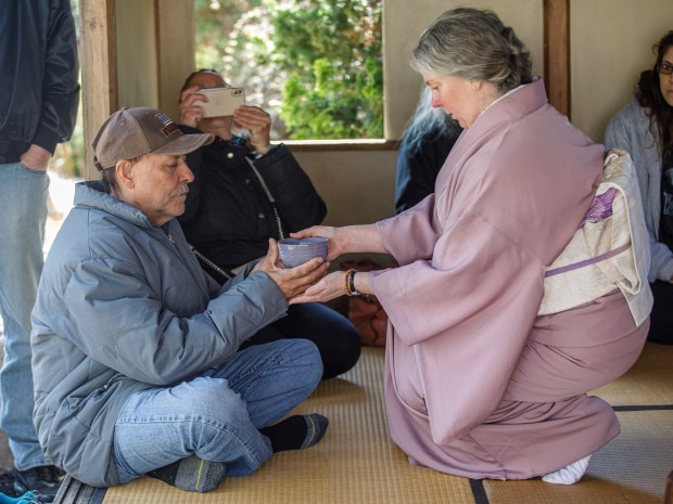 Michael Owen of Danielsville is served tea by Tea Artist Cristina Major during the Bethlehem-Tondabayashi Sister City Commission's annual Cherry Blossom Festival on Saturday, March 28, 2026, at the Garden of Serenity in Bethlehem. The festival featured Japanese music, food, origami and tea ceremonies. (Jane Therese/Special to The Morning Call)
