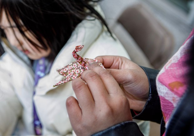 Hajar Syamsuddin, 13, of Allentown makes an origami during the Bethlehem-Tondabayashi Sister City Commission's annual Cherry Blossom Festival on Saturday, March 28, 2026, at the Garden of Serenity in Bethlehem. The festival featured Japanese music, food, origami and tea ceremonies. (Jane Therese/Special to The Morning Call)