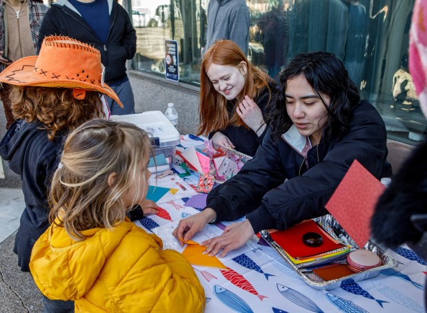Children are shown how to make an origami during the Bethlehem-Tondabayashi Sister City Commission's annual Cherry Blossom Festival on Saturday, March 28, 2026, at the Garden of Serenity in Bethlehem. The festival featured Japanese music, food, origami and tea ceremonies. (Jane Therese/Special to The Morning Call)