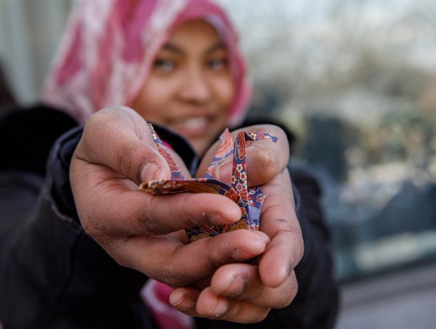 Hajar Syamsuddin, 13, of Allentown shows off her origami during the Bethlehem-Tondabayashi Sister City Commission's annual Cherry Blossom Festival on Saturday, March 28, 2026, at the Garden of Serenity in Bethlehem. The festival featured Japanese music, food, origami and tea ceremonies. (Jane Therese/Special to The Morning Call)
