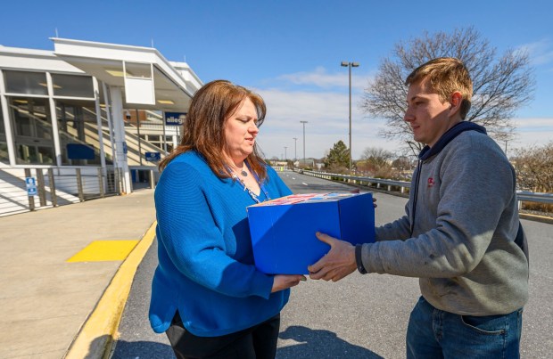 David Noecker of New Ringgold passes donated nonperishable items to passenger services manager Marcy Work during a Fill the Bus donation drive Thursday, March 19, 2026, at Lehigh Valley International Airport. More than 20 carts were filled with donated paper products; toiletries, diapers and other baby products; gift cards; and nonperishable foods and beverages for Transportation Security Administration and Federal Aviation Administration workers at the airport who aren't being paid during the partial federal government shutdown. (April Gamiz/The Morning Call)