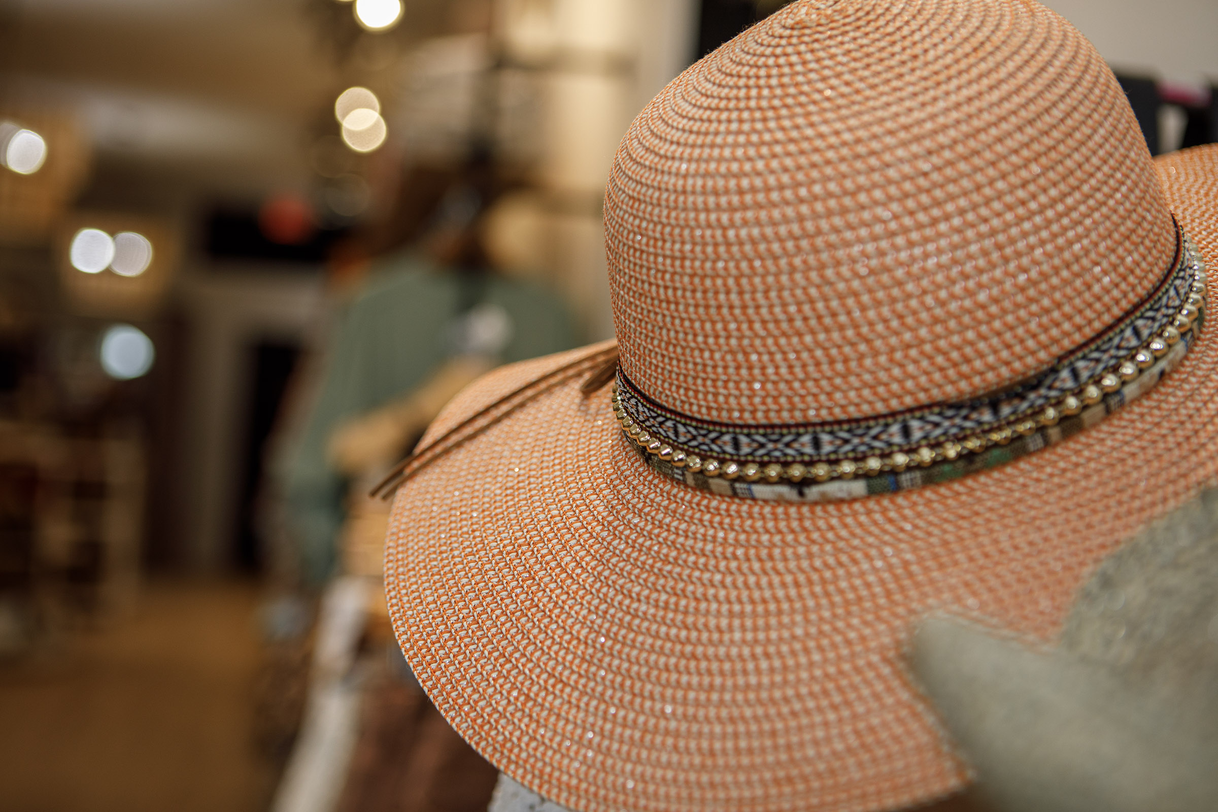 A sun hat on display inside Indulge Designer Resale Boutique...