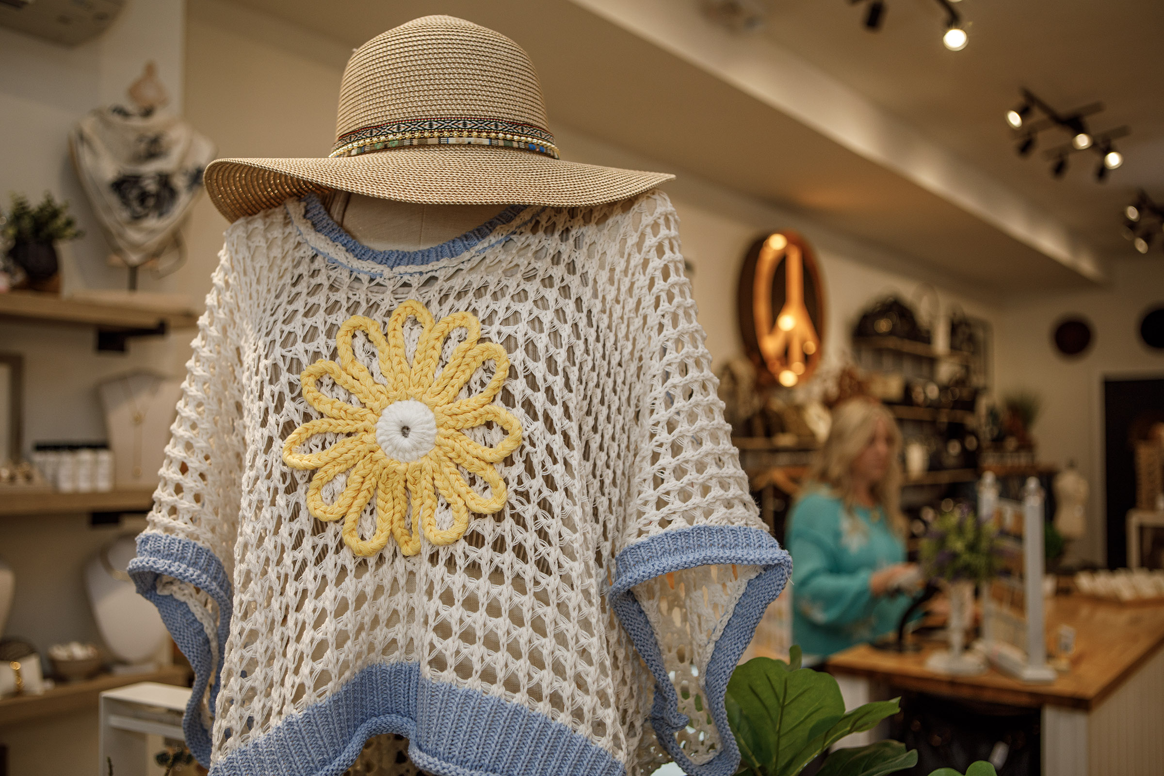 A clothing display inside Indulge Designer Resale Boutique poses inside...