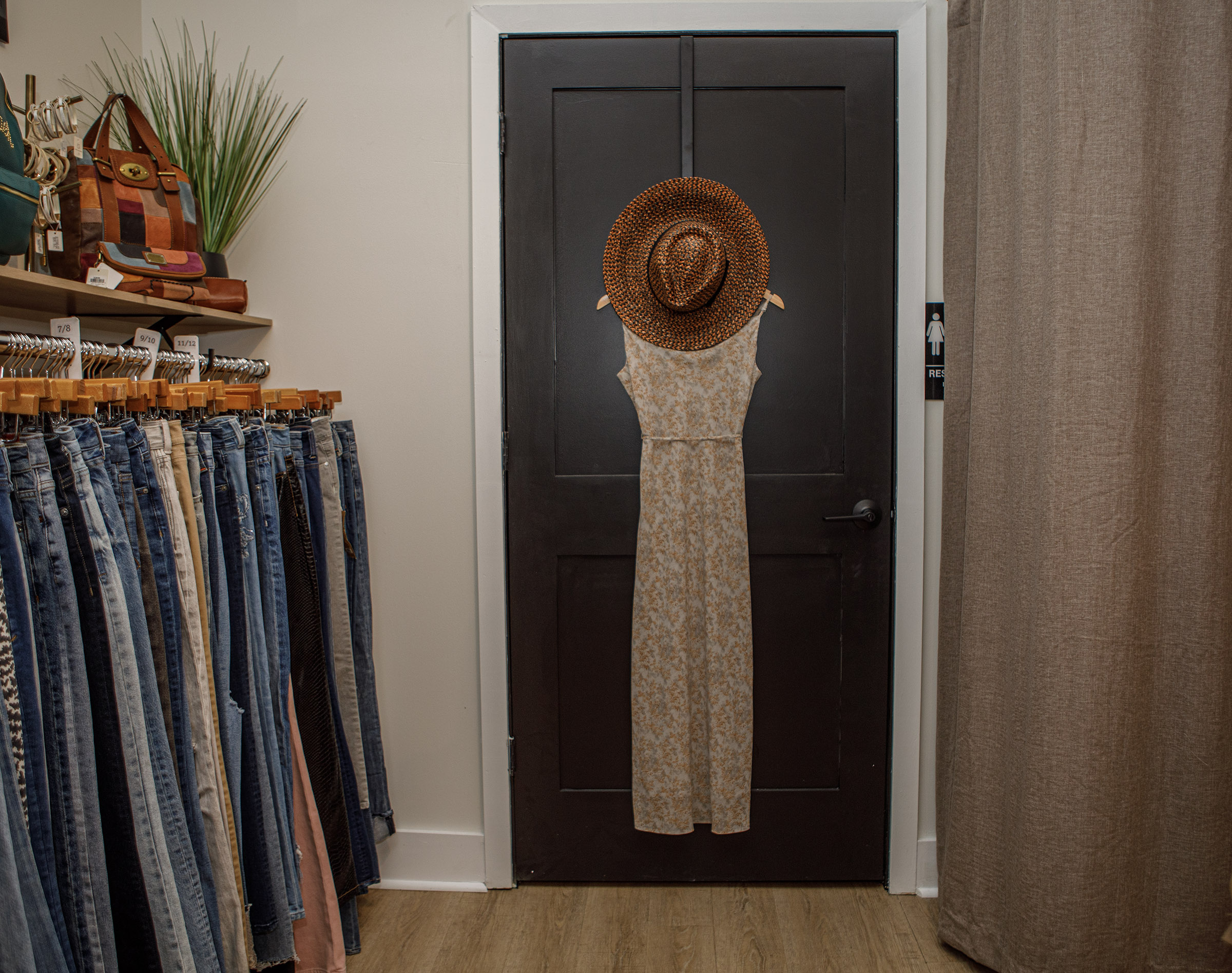 A clothing display inside Indulge Designer Resale Boutique poses inside...