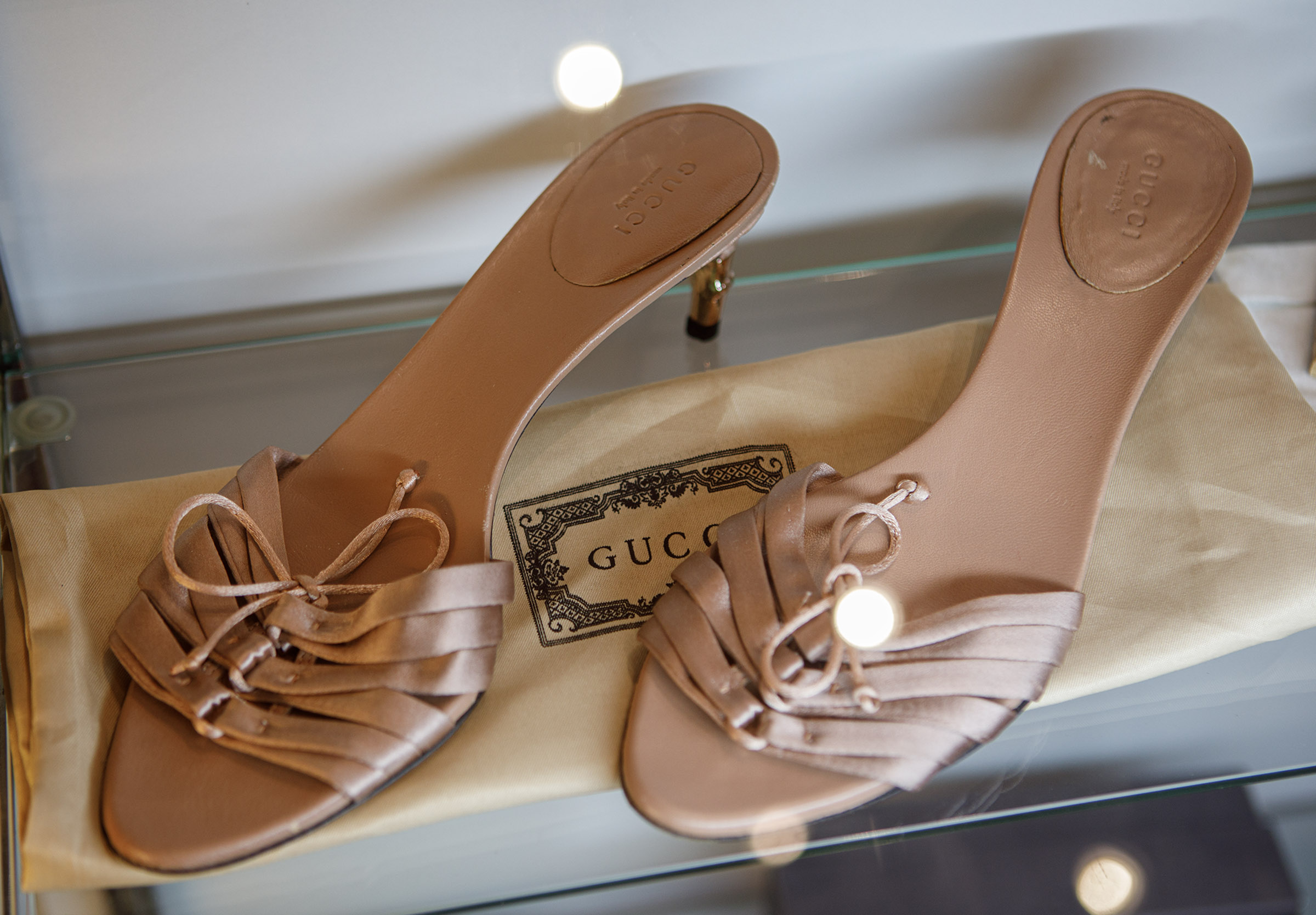 Vintage Gucci heels inside Indulge Designer Resale Boutique poses inside...