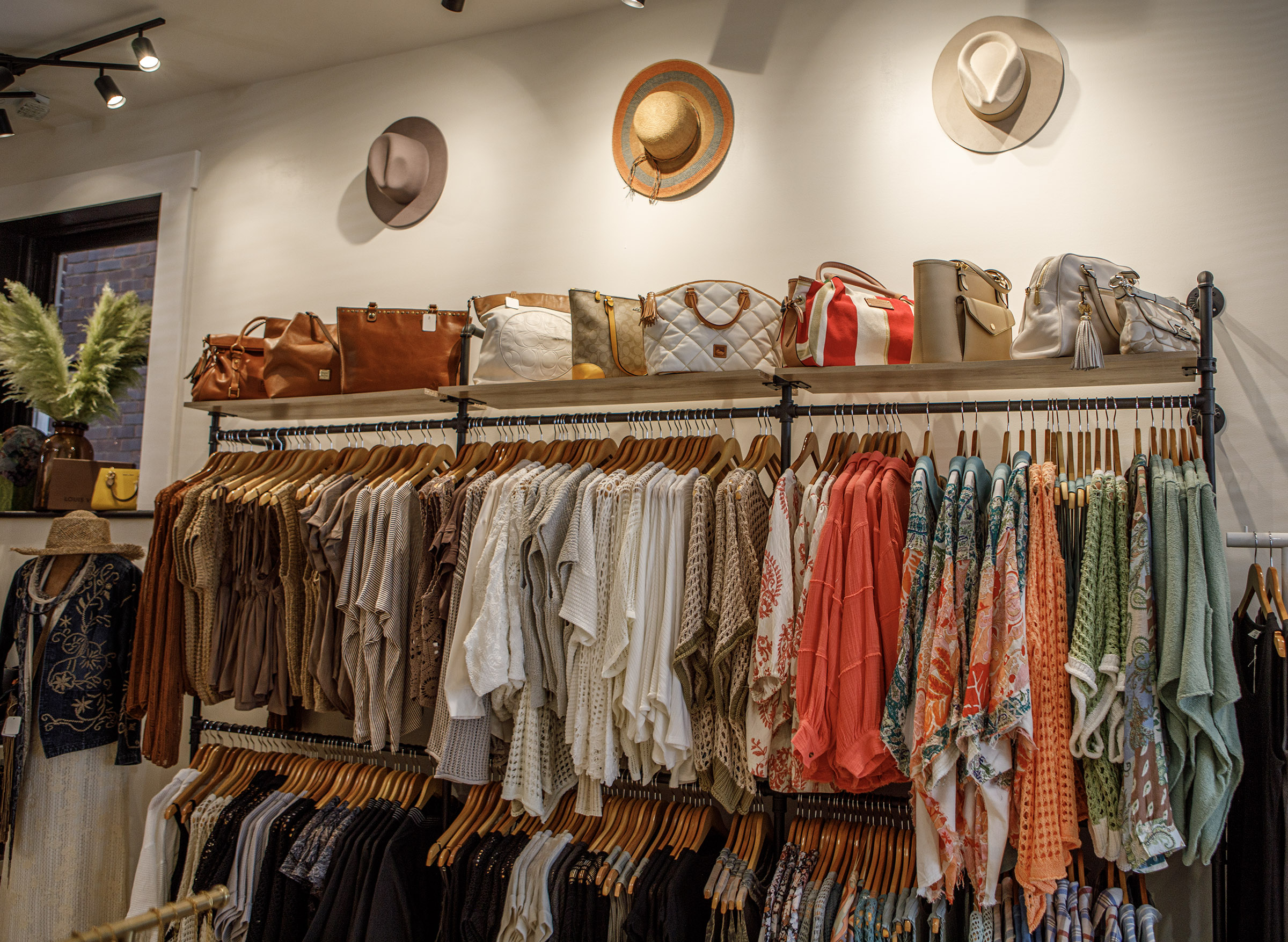 A display inside Indulge Designer Resale Boutique poses inside her...