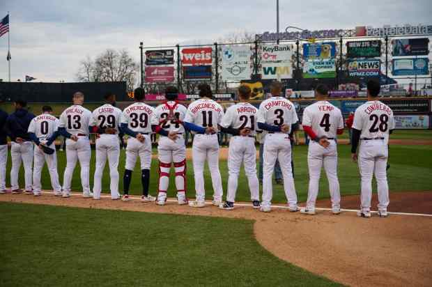 The Lehigh Valley IronPigs' during the National Anthem Friday, in their season opener against Scranton/Wilkes-Barre at Coca- Cola Park in Allentown. (David Garrett/Special to The Morning Call)