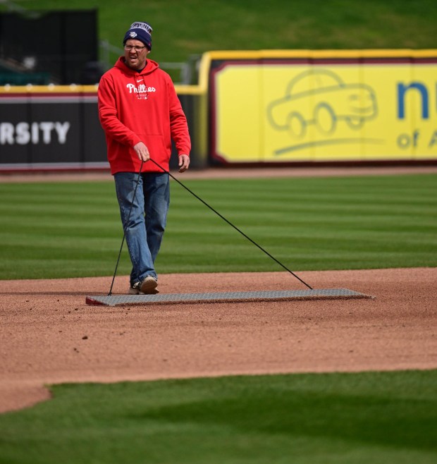 A worker smooths the infield baseline with a drag mat Wednesday, March 25, 2026, during media day at Coca-Cola park in Allentown. (Monica Cabrera/The Morning Call)