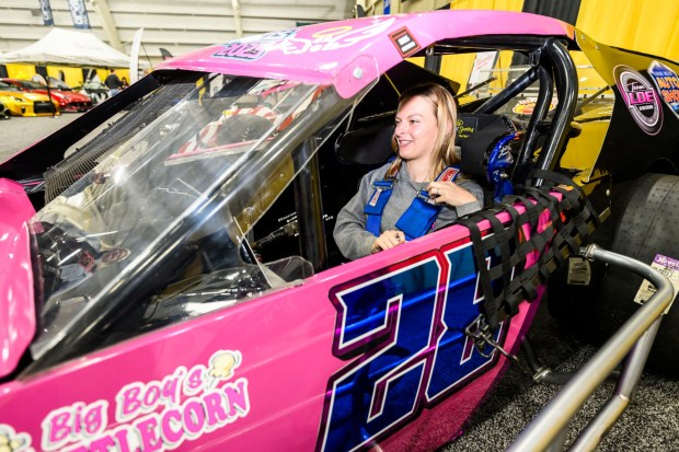Driver Makayla Kohler of Schnecksville demonstrates how she enters and buckles into her Crate 602 Modified race car on Wednesday, March 18, 2026, during Lehigh Valley Auto Show 2026 at Lehigh University's Goodman Campus in Bethlehem. The show features more than 400 vehicles from 66 different brands and runs Thursday-Saturday: 10 a.m.- 8 p.m.; Sunday: 10 a.m.-5 p.m. (April Gamiz/The Morning Call)