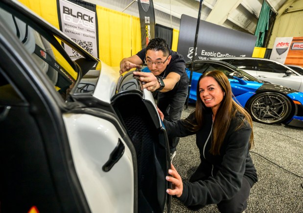 Matt Hawkins and Kristie Moyer of Black Glass Tint, prep a McLaren 570S to be wrapped Wednesday, March 18, 2026, during Lehigh Valley Auto Show 2026 at Lehigh University's Goodman Campus in Bethlehem. The show features more than 400 vehicles from 66 different brands and runs Thursday-Saturday: 10 a.m.- 8 p.m.; Sunday: 10 a.m.-5 p.m. (April Gamiz/The Morning Call)