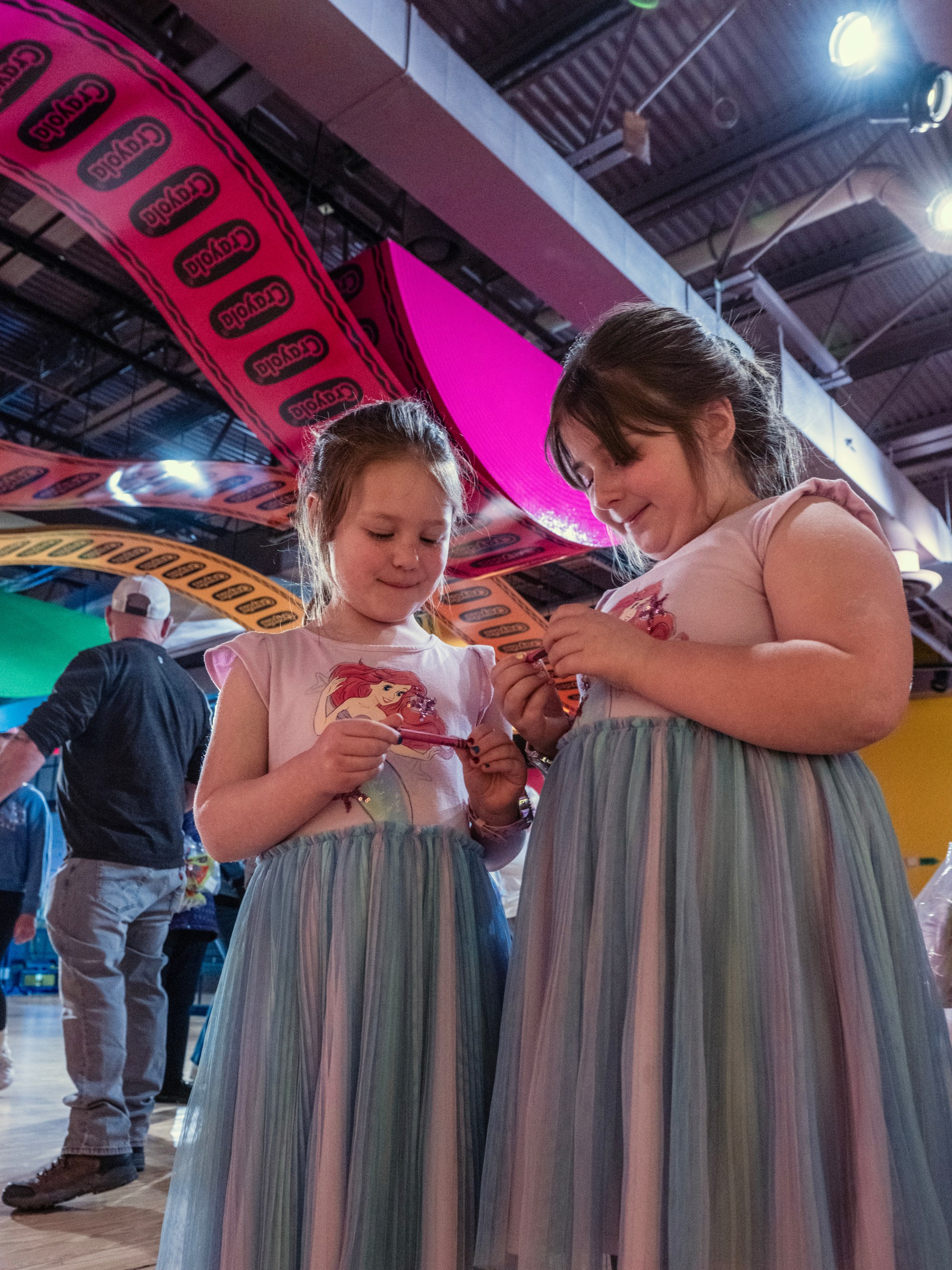 Sisters Emily Stewart, 5, and Olivia Stewart, 7, look at their personalized Red Violet crayons Monday, March 30, 2026, at the Crayola Experience in Easton. They were excited because they had just arrived already found a letter "N" hanging from the ceiling as part of a scavenger hunt activity leading up to National Crayon Day on Tuesday. Hundreds of crayon lovers will be celebrating with Crayola Experience, kicking off the brand's Million Crayon Giveaway by creating their free, one-of-a-kind crayon box. Families registered for the giveaway will have the colorful experience of customizing a 32-count crayon box with any color assortment of their favorite Crayola crayons from a 40-foot-long Pick Your Pack wall holding nearly half a million crayonsincluding the official return of the beloved Crayola color Dandelionfor good. (Monica Cabrera/The Morning Call)