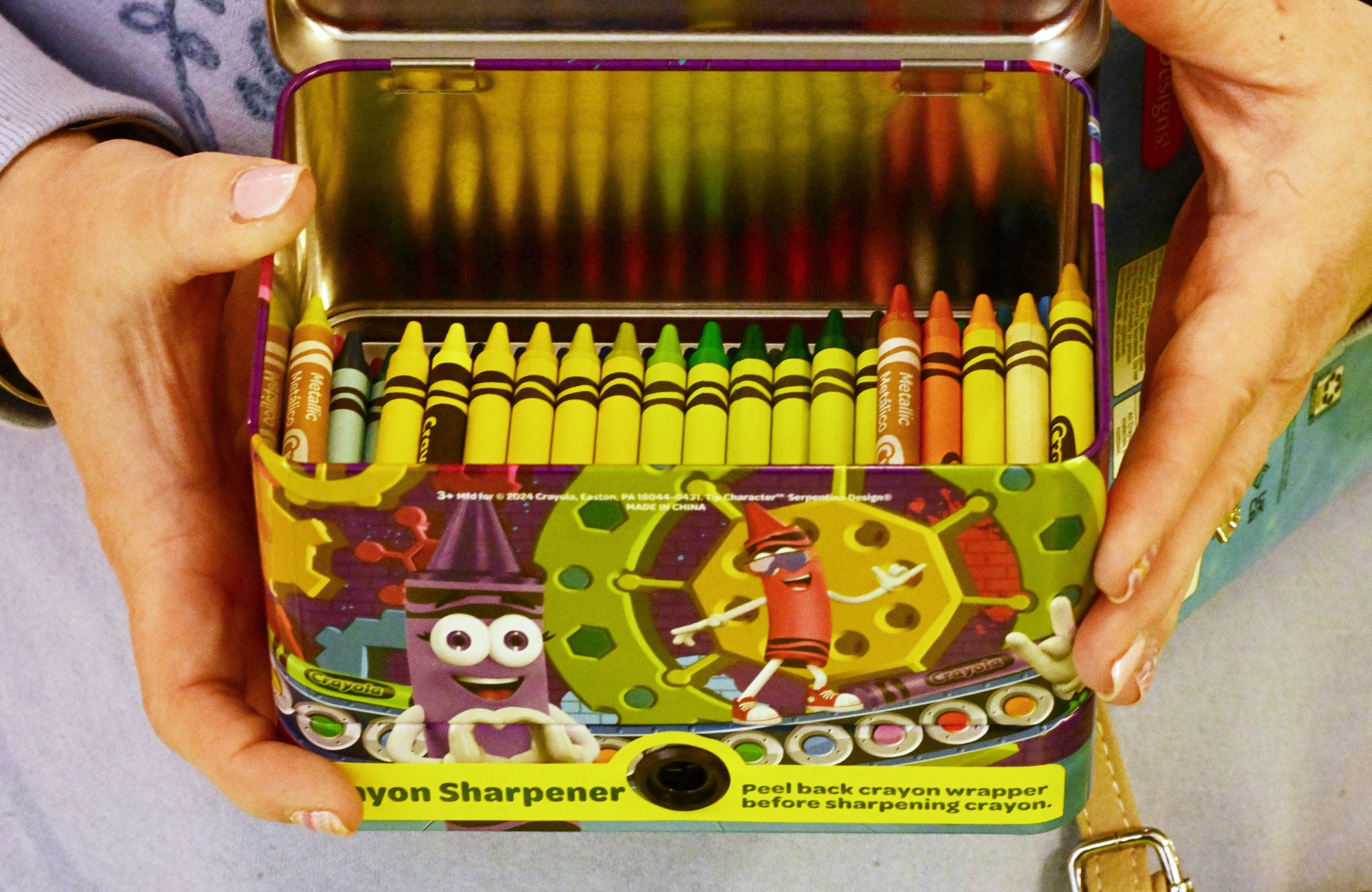 Janine Busack of Reading, chooses Monday, March, 30, 2026, crayon colors and put's them in a box to share with children in her family come to visit. She said it was perfect to pic her own to choose all the colors in the rainbow. The Crayola Experience in Easton had many activities to enjoy including a Scavenger Hunt, leading up to National Crayon Day which is Tuesday, March 31, 2026. (Monica Cabrera/The Morning Call)