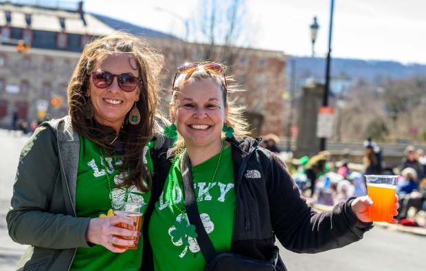 Kelly Neumann and Jennifer Badame, both of Kutztown, enjoy the festivities Saturday, March 14, 2026, during the 16th annual Parade of Shamrocks in downtown Bethlehem. The parade was presented by the Celtic Cultural Alliance and Historic Hotel Bethlehem. The St. Patrick's Day celebration featured pipe bands, school marching bands and community groups, starting on Broad Street and ending under the Hill-To-Hill Bridge.(April Gamiz/The Morning Call)