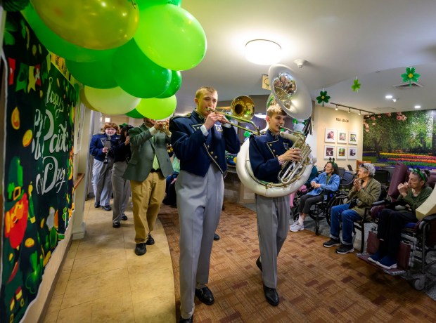 Connor Holcombe and Ben Ruppe, members of the Notre Dame-Green Pond Crusaders Band, play the trombone and tuba Tuesday, March 17, 2026, during a St. Patrick's Day celebration at Arden Courts Old Orchard, a memory care community, in Bethlehem Township. (April Gamiz/The Morning Call)