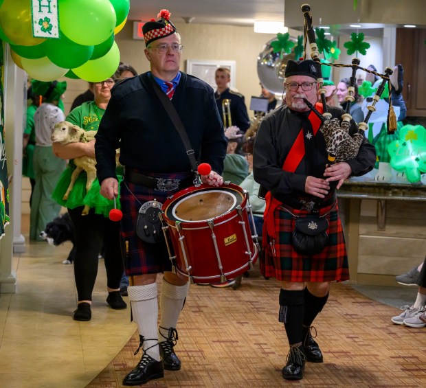 James Ruhf plays the bagpipes and Mac Peeke plays the drum as they lead a parade Tuesday, March 17, 2026, during a St. Patrick's Day celebration at Arden Courts Old Orchard, a memory care community, in Bethlehem Township. (April Gamiz/The Morning Call)