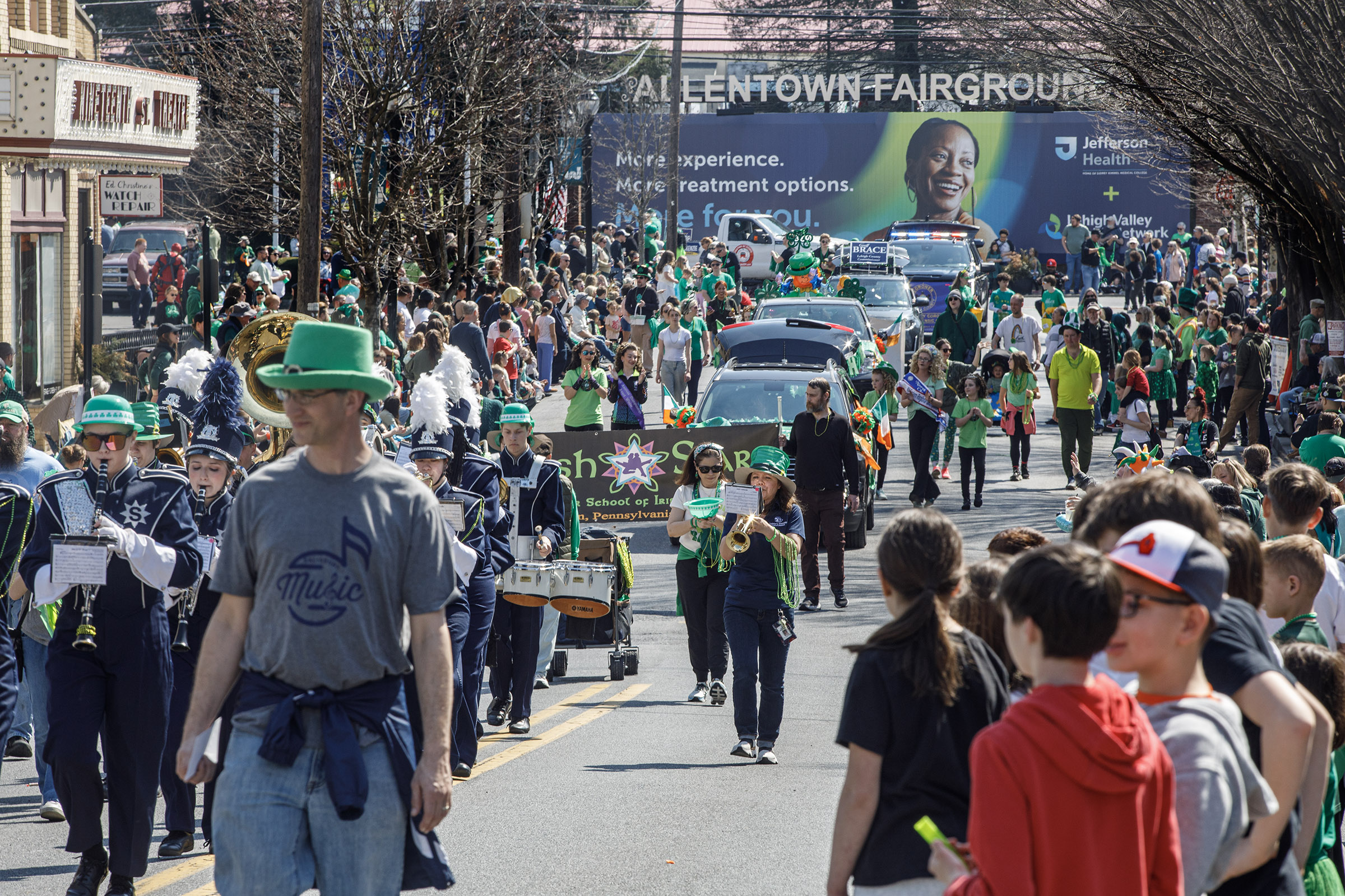 People line the streets during the start of the St....