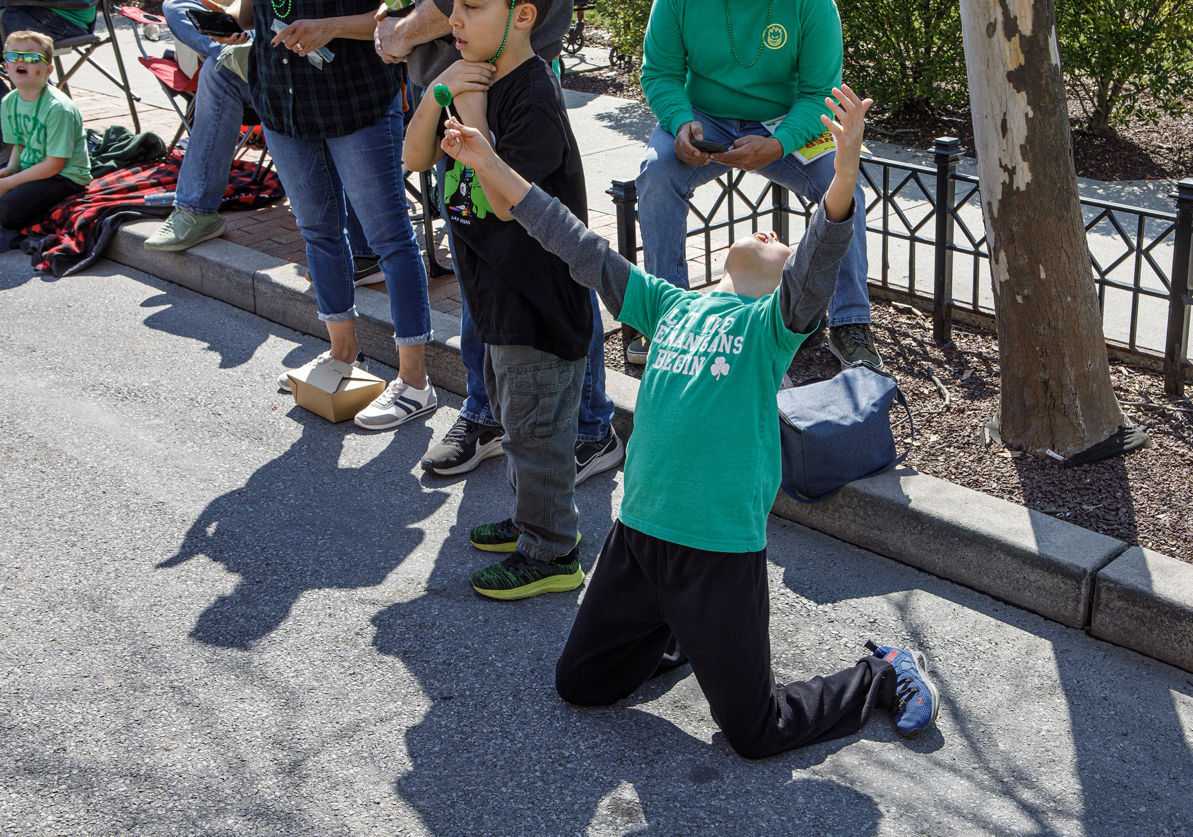 Kids grapple for candy during the St. Patrickâs Parade on...