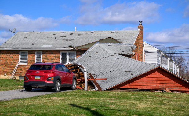 Storm damage from Monday night's strong winds is seen Tuesday, March 17, 2026, at a house on Devonshire Road in Allentown. Storms blew off roofs and downed trees and power lines around the Lehigh Valley, leaving thousands without electricity. (April Gamiz/The Morning Call)