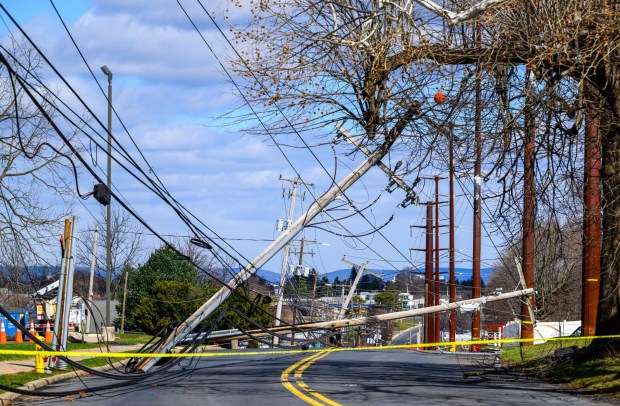 Power lines are down Tuesday, March 17, 2026, along South 12th Street in Allentown after Monday night's strong winds. Storms blew off roofs and downed trees and power lines around the Lehigh Valley, leaving thousands without electricity. (April Gamiz/The Morning Call)