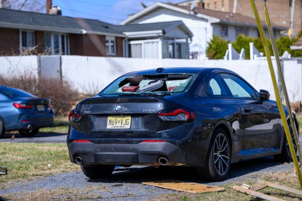 Storm damage from Monday night's strong winds is seen Tuesday, March 17, 2026, in an alleyway between Devonshire Road and South 12th Street in Allentown. Storms blew off roofs and downed trees and power lines around the Lehigh Valley, leaving thousands without electricity. (April Gamiz/The Morning Call)
