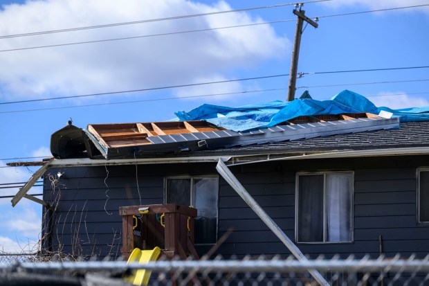 Storm damage from Monday night's strong winds is seen Tuesday, March 17, 2026, in an alleyway between Devonshire Road and South 12th Street in Allentown. Storms blew off roofs and downed trees and power lines around the Lehigh Valley, leaving thousands without electricity. (April Gamiz/The Morning Call)