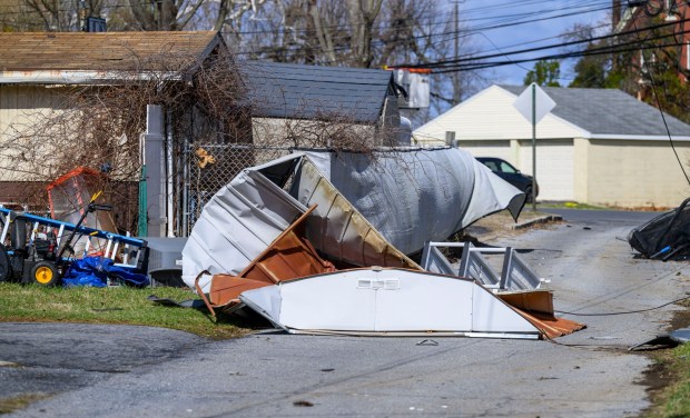 Storm damage from Monday night's strong winds is seen Tuesday, March 17, 2026, in an alleyway between Devonshire Road and South 12th Street in Allentown. Storms blew off roofs and downed trees and power lines around the Lehigh Valley, leaving thousands without electricity. (April Gamiz/The Morning Call)
