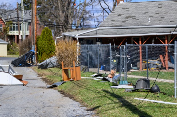 Storm damage from Monday night's strong winds is seen Tuesday, March 17, 2026, in an alleyway between Devonshire Road and South 12th Street in Allentown. Storms blew off roofs and downed trees and power lines around the Lehigh Valley, leaving thousands without electricity. (April Gamiz/The Morning Call)