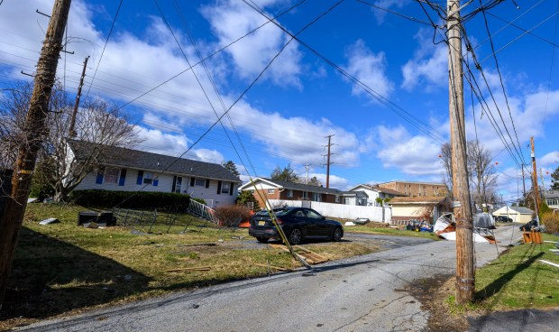 Storm damage from Monday night's strong winds is seen Tuesday, March 17, 2026, in an alleyway between Devonshire Road and South 12th Street in Allentown. Storms blew off roofs and downed trees and power lines around the Lehigh Valley, leaving thousands without electricity. (April Gamiz/The Morning Call)