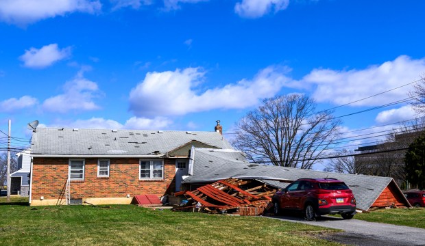 Storm damage from Monday night's strong winds is seen Tuesday, March 17, 2026, at a house on Devonshire Road in Allentown. Storms blew off roofs and downed trees and power lines around the Lehigh Valley, leaving thousands without electricity. (April Gamiz/The Morning Call)