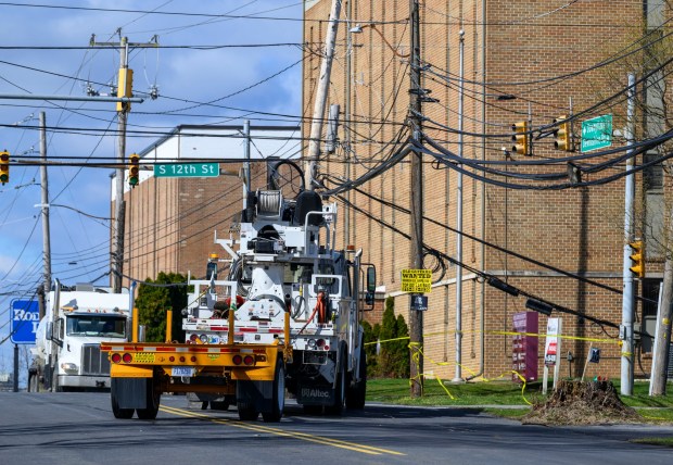 Power lines are down Tuesday, March 17, 2026, along South 12th Street in Allentown after Monday night's strong winds. Storms blew off roofs and downed trees and power lines around the Lehigh Valley, leaving thousands without electricity. (April Gamiz/The Morning Call)
