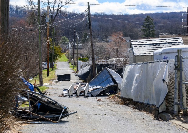 Storm damage from Monday night's strong winds is seen Tuesday, March 17, 2026, in an alleyway between Devonshire Road and South 12th Street in Allentown. Storms blew off roofs and downed trees and power lines around the Lehigh Valley, leaving thousands without electricity. (April Gamiz/The Morning Call)